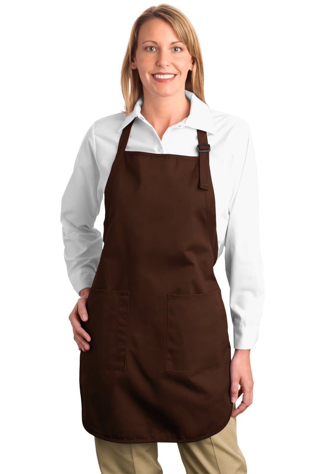 A woman wearing a brown full-length apron with pockets over a white shirt, featuring a logo.