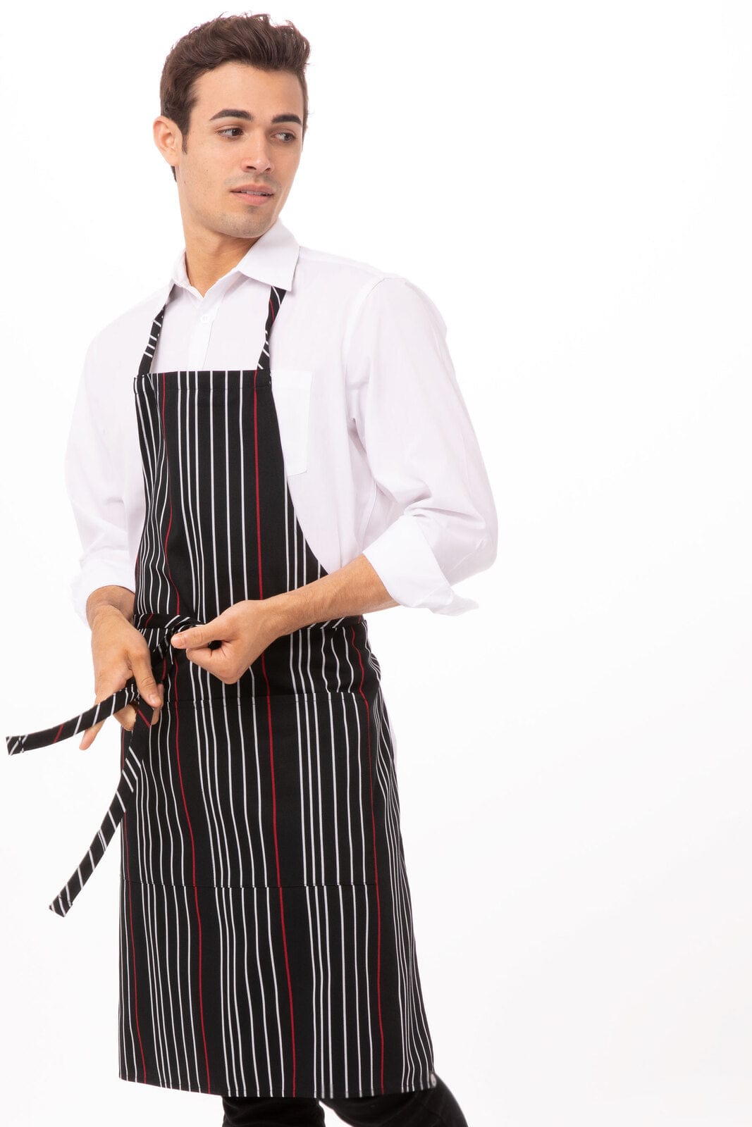 A striped bib apron in black and white with red accents, worn by a model. The design includes an adjustable neck strap.