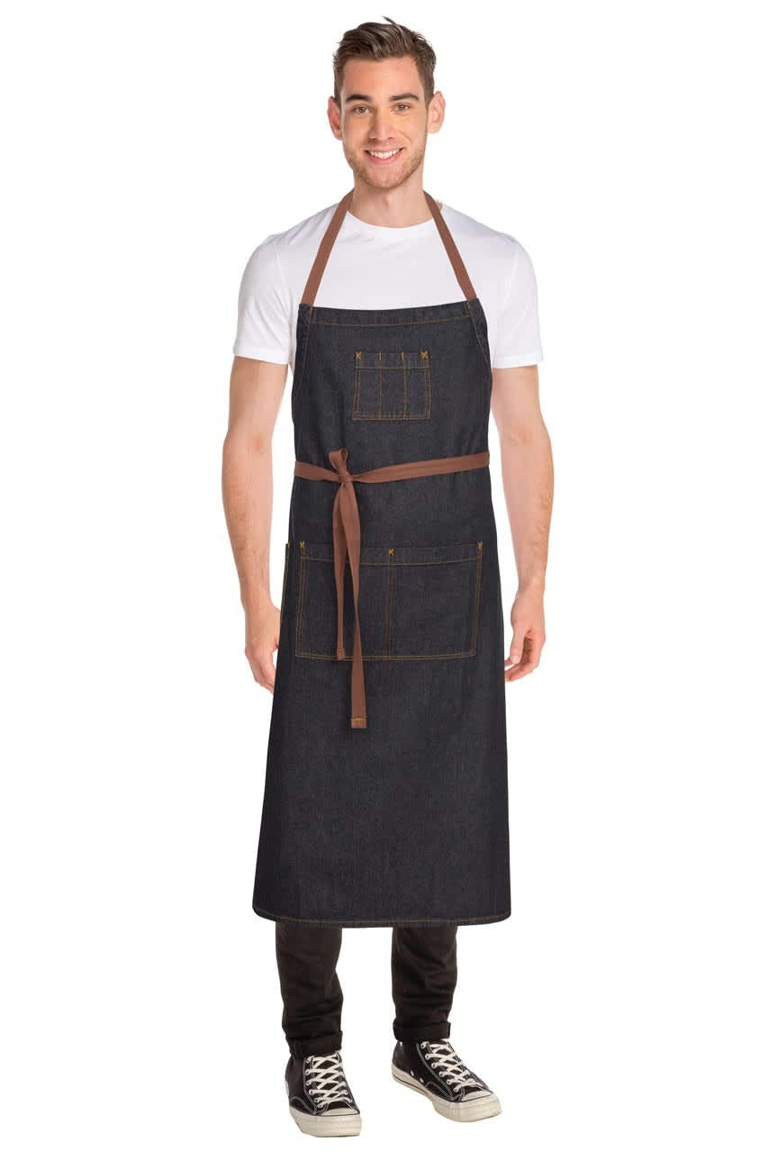 A dark denim apron with a brown tie and pockets, worn by a model. It features a logo on the front.