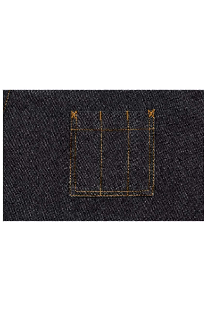 A close-up of a dark denim apron pocket with contrasting yellow stitching, featuring a square design.