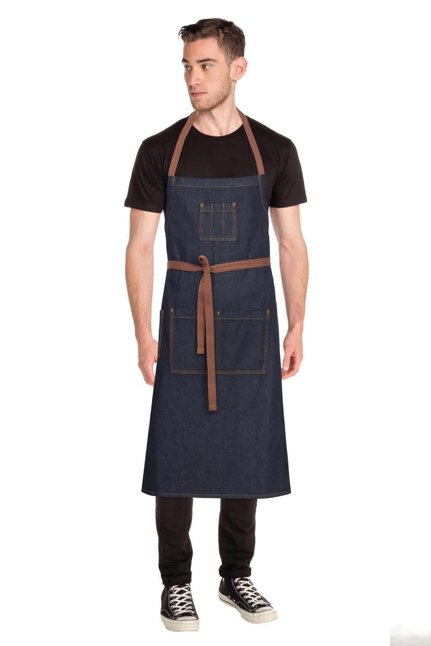 A navy blue chef's bib apron with brown straps, featuring pockets, displayed on a model.