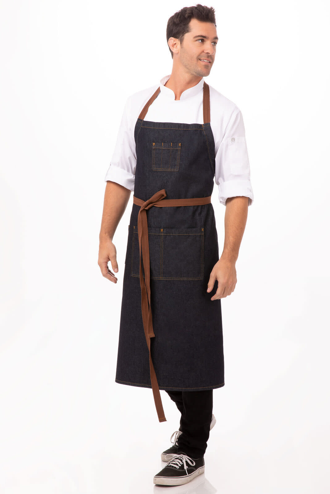 A denim chef's bib apron with brown straps, featuring pockets and a logo on the chest.
