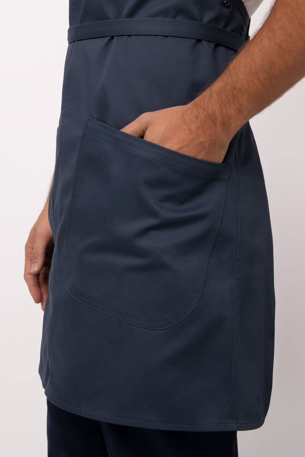 A dark blue Largo Bib Apron featuring a large front pocket and adjustable straps. It has a logo on the side.