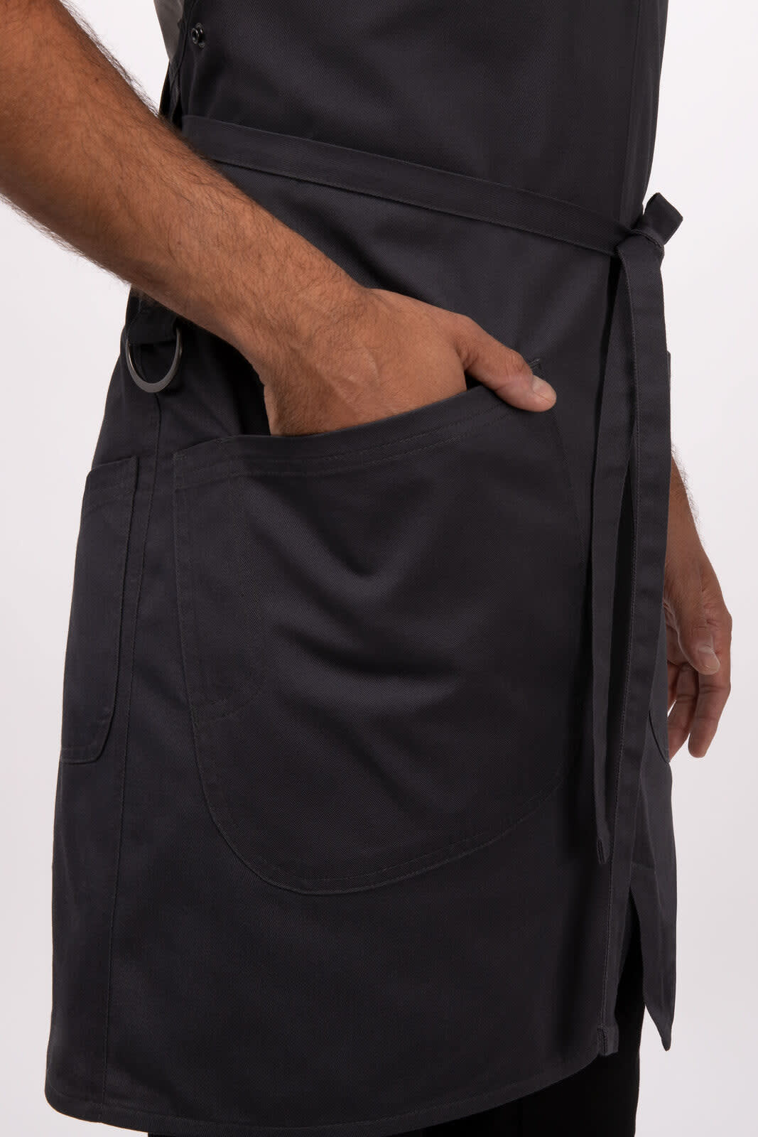 A dark grey Largo Bib Apron featuring a front pocket and a waist tie. The apron has a simple, modern design.