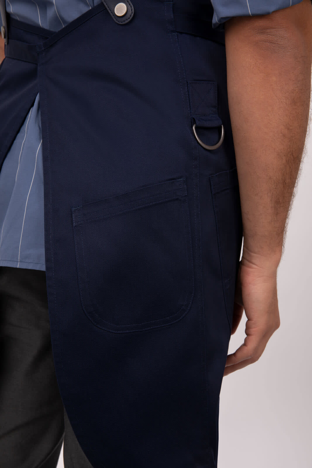 A navy blue Largo Bib Apron featuring side pockets and adjustable straps, with a logo on the front.