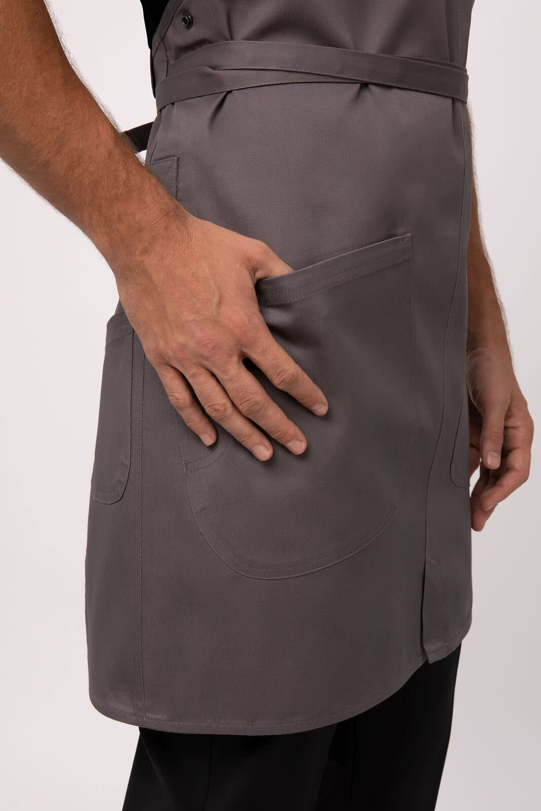 A grey Largo Bib Apron features a front pocket and ties, showcasing a sleek design for workwear.