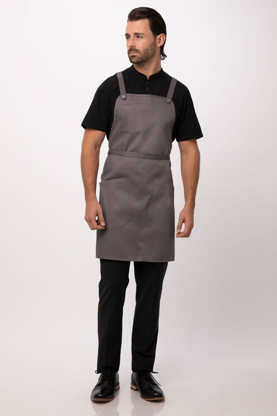 A grey Largo Bib Apron worn by a model, featuring adjustable straps and a logo.