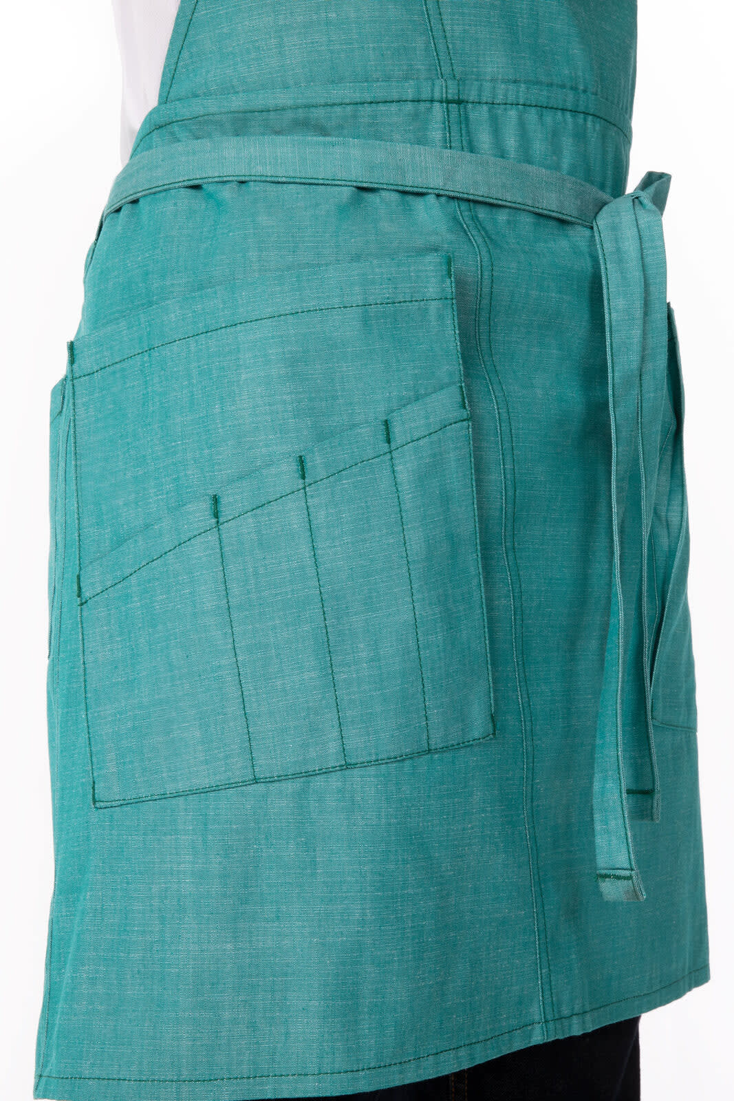 A turquoise Medford Bib Apron with a pocket and adjustable tie at the waist, featuring a logo.