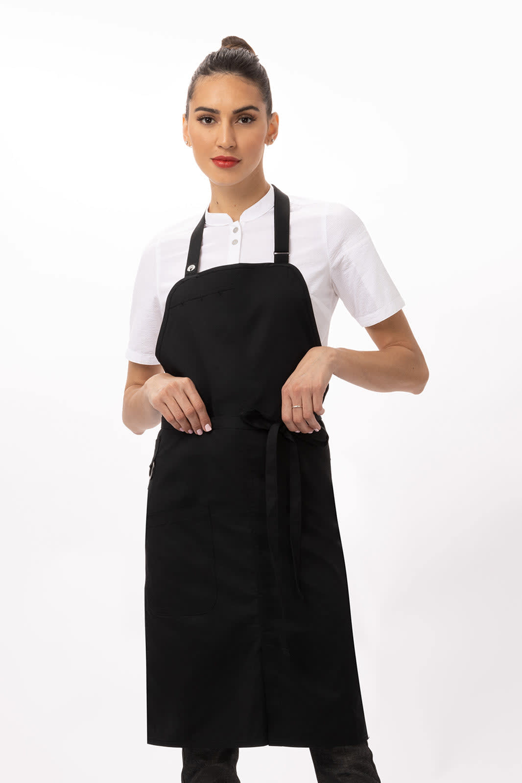 A black apron with adjustable straps and a waist tie, styled with a white shirt. It features a logo.