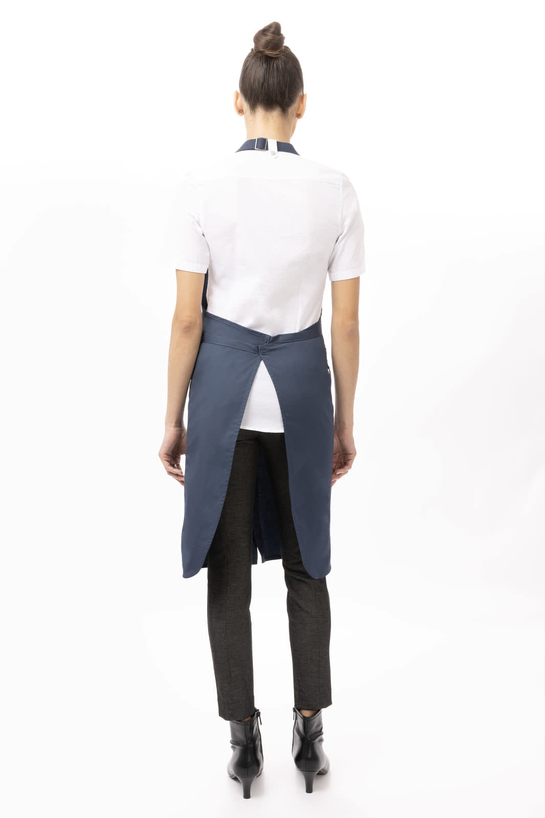 A navy Brio Bib Apron worn by a person from the back, featuring a simple design and a logo.