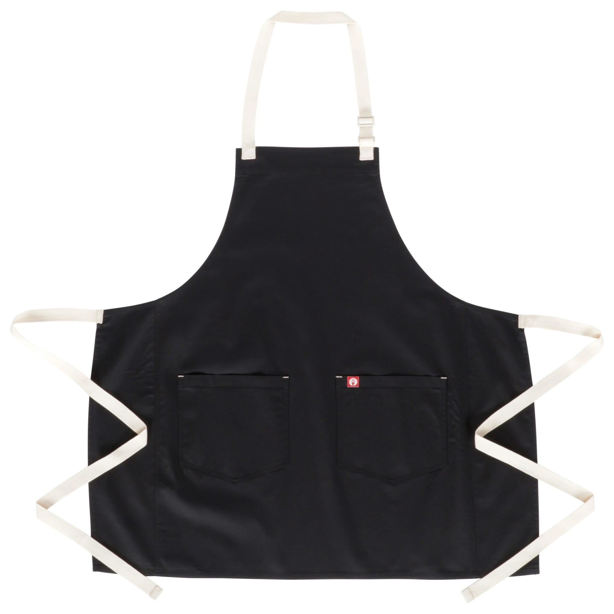 A black bib apron with cream straps and two front pockets, featuring a small logo.