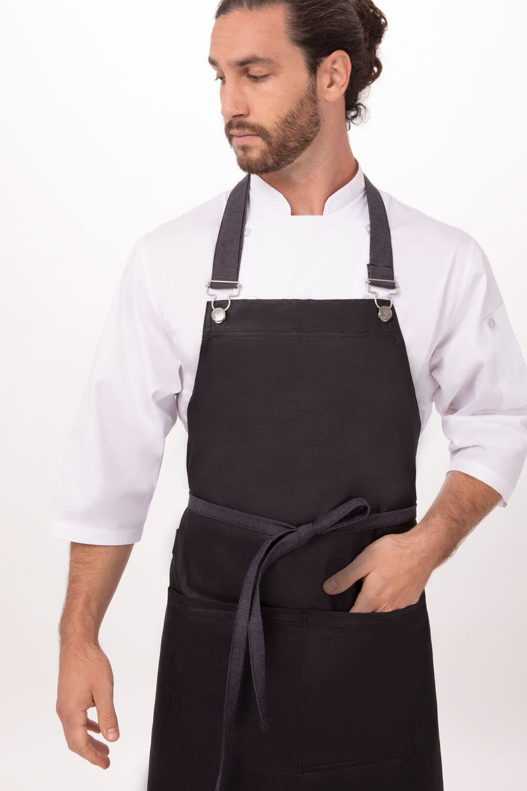 A black Boulder Bib Apron worn by a man in a white shirt, featuring a logo and adjustable straps.