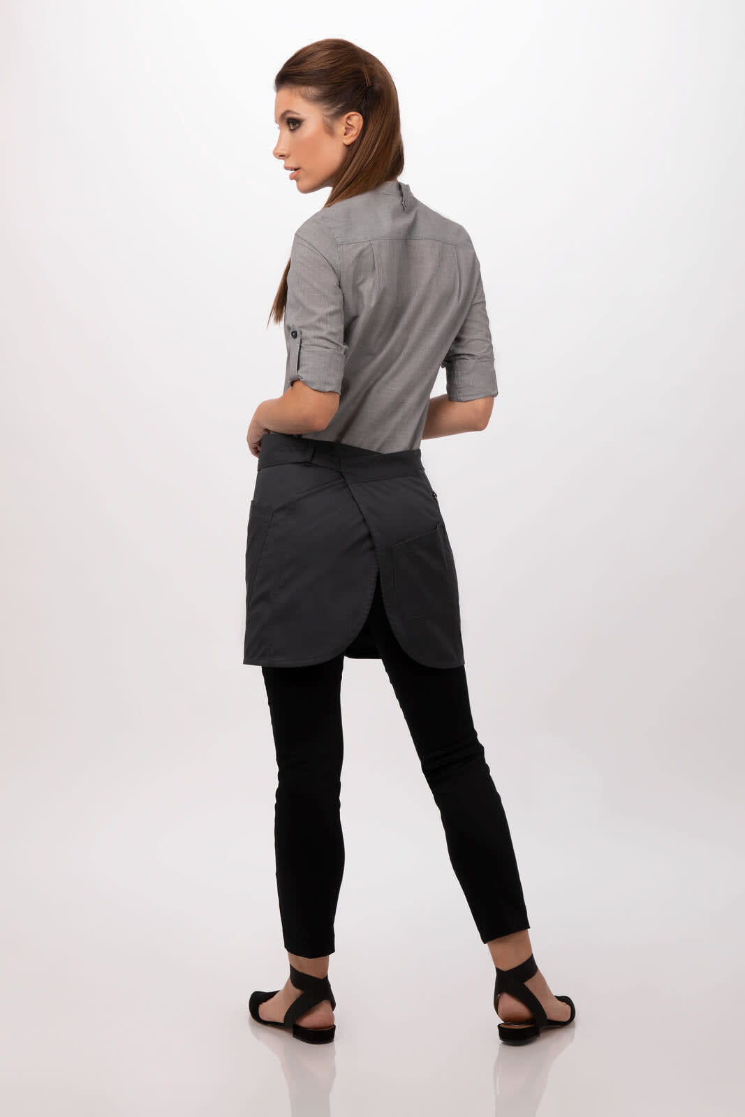 A grey half bistro apron worn over black pants, featuring a sleek design and a logo.