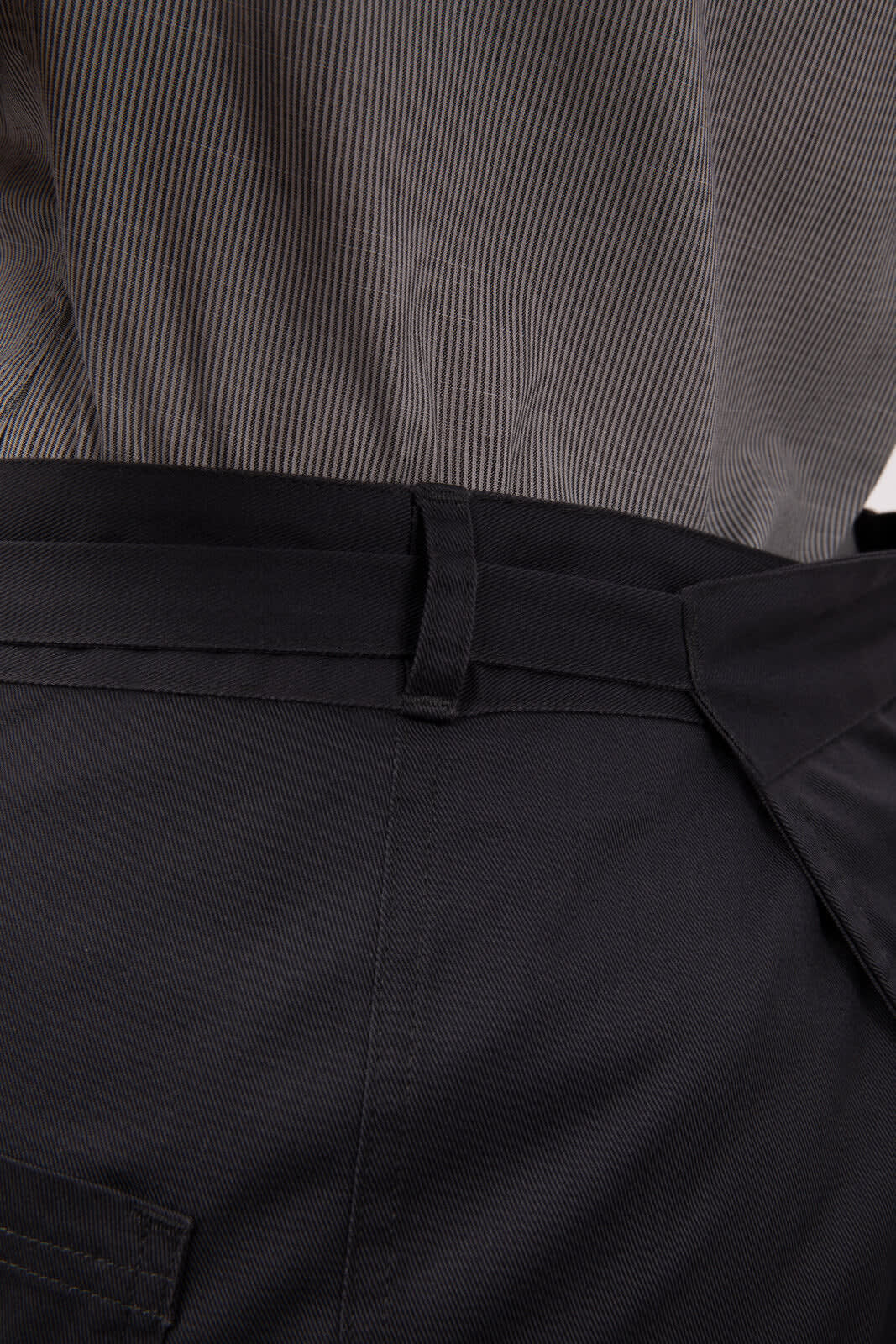A black half bistro apron with a waist tie, featuring a plain design and no visible branding.