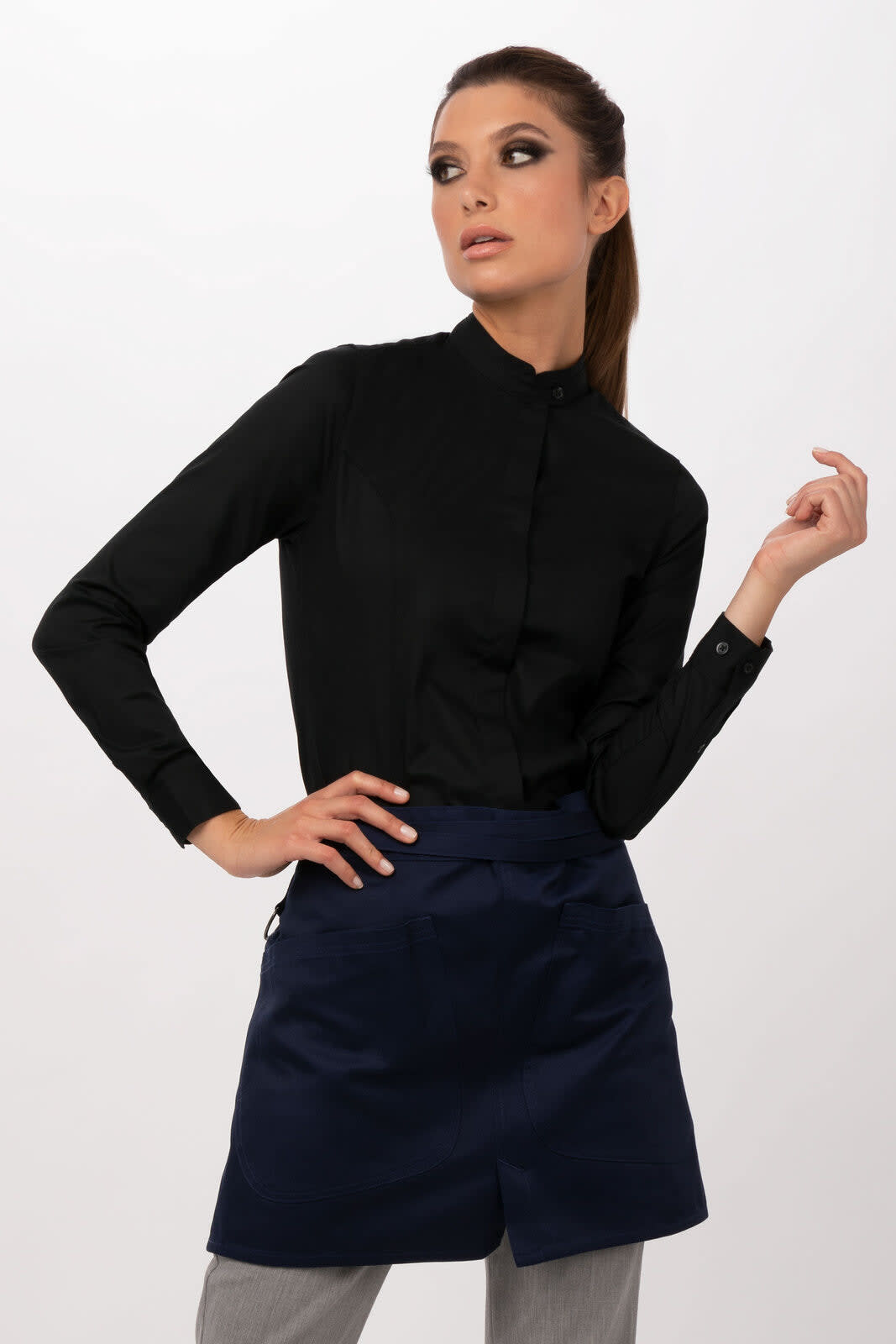 A model wearing a black long-sleeve shirt and a navy blue Largo Half Bistro Apron, posing against a light background.