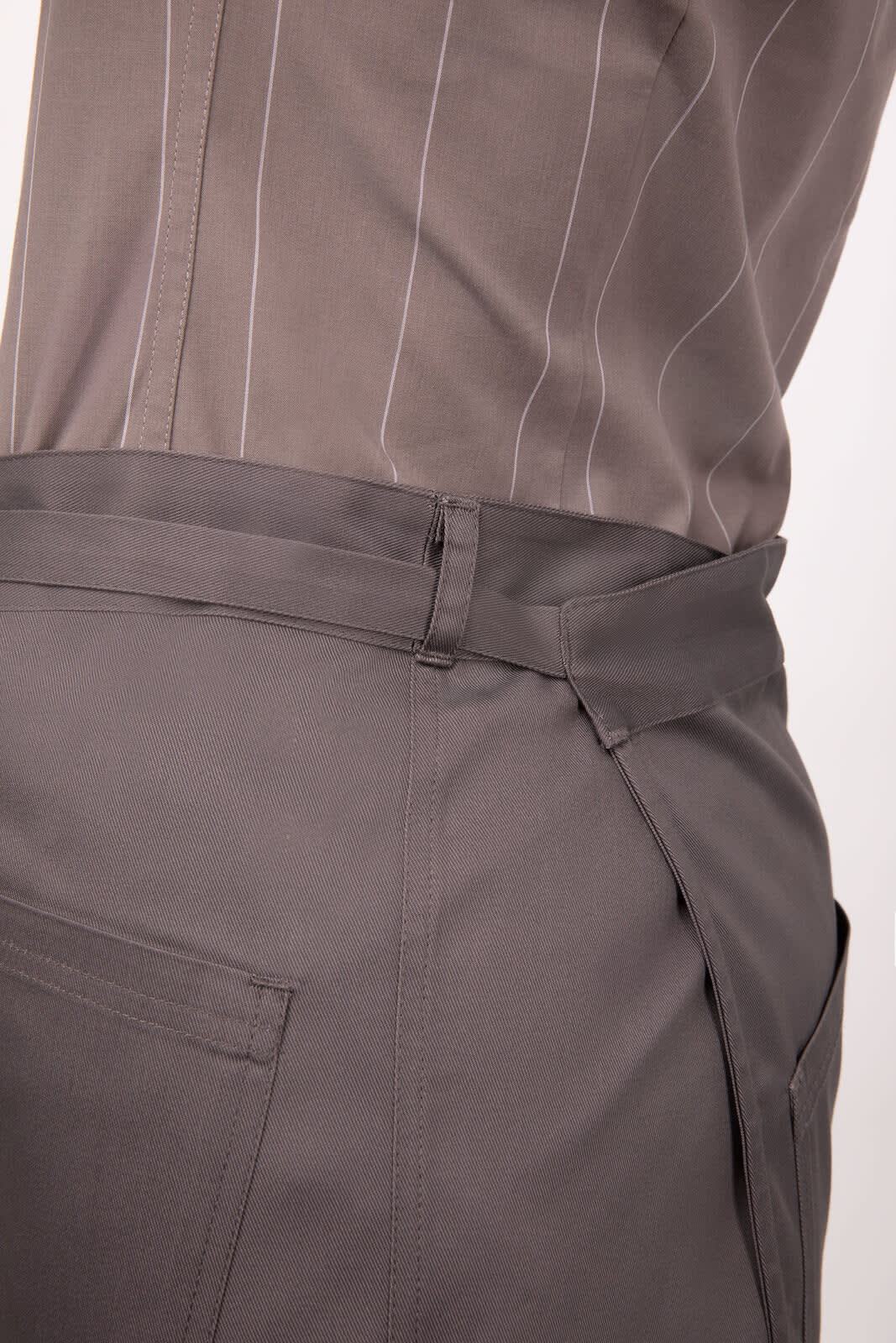 A grey half bistro apron with a side tie and a pocket, featuring a smooth fabric and simple design.