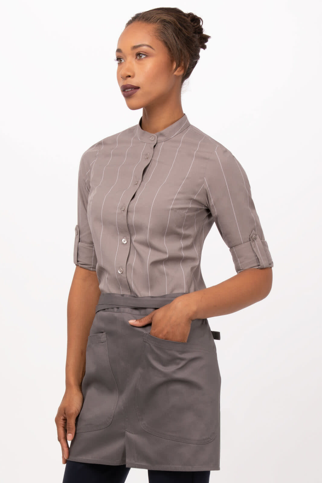A model wearing a grey striped shirt paired with a grey Largo Half Bistro Apron featuring pockets.