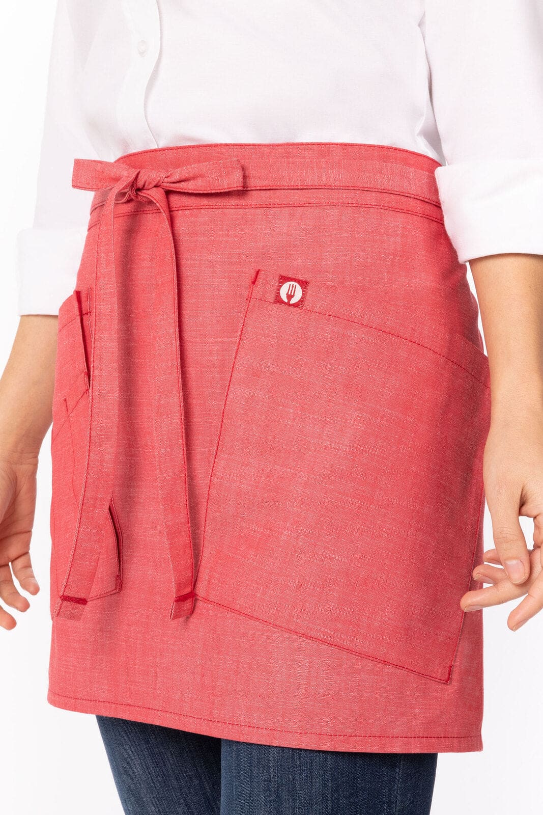 A pink bistro apron with a tie at the waist and two front pockets, featuring a logo.