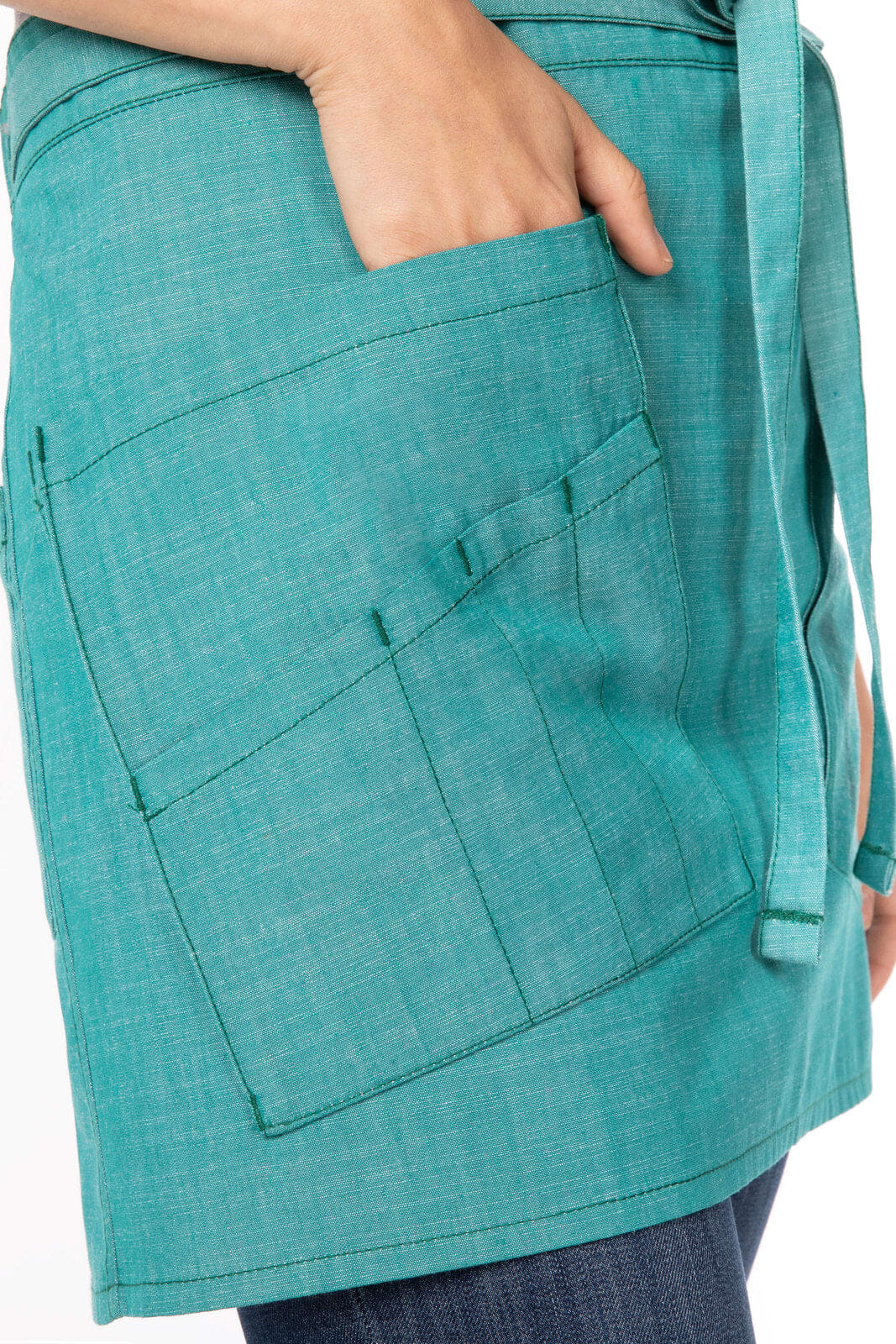 A turquoise bistro apron featuring multiple pockets and a waist tie, showcasing a textured fabric design.
