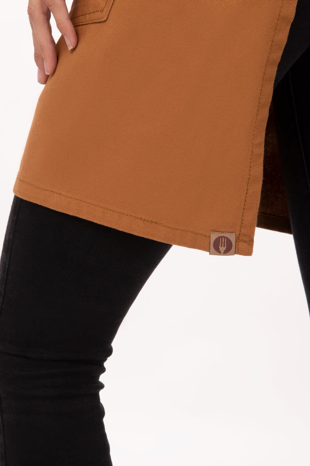 A brown half bistro apron with a side slit and a logo at the hem, paired with black pants.
