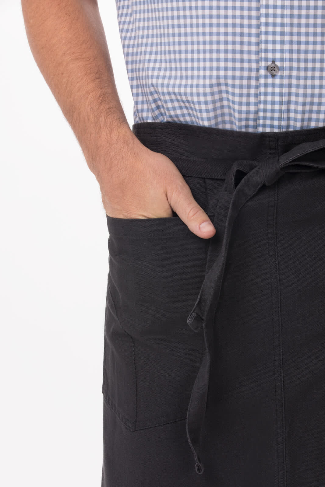 A black half bistro apron featuring a front pocket, worn over a checked shirt, with a waist tie.