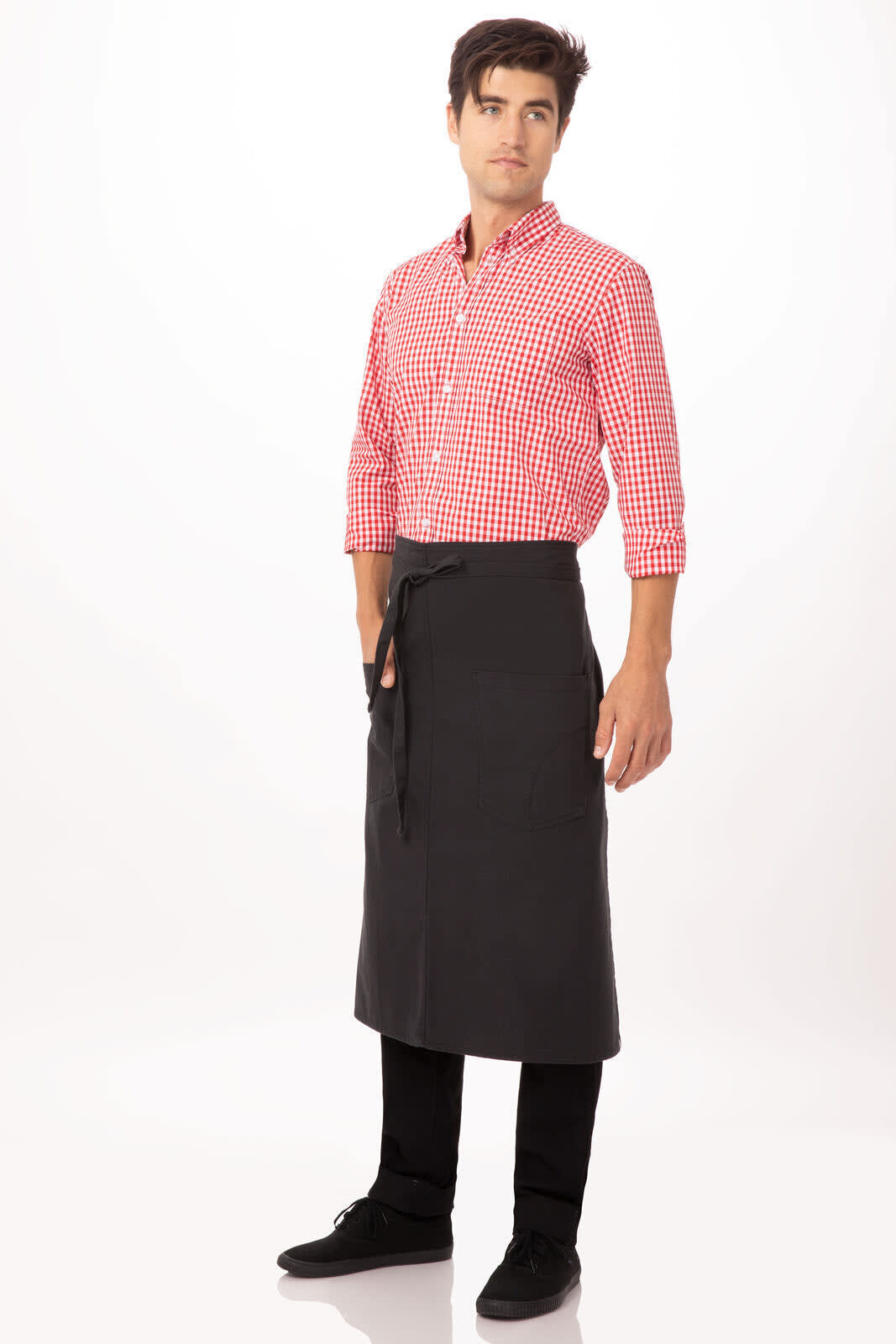 A male model wearing a black bistro apron over a red checkered shirt, standing against a light background.