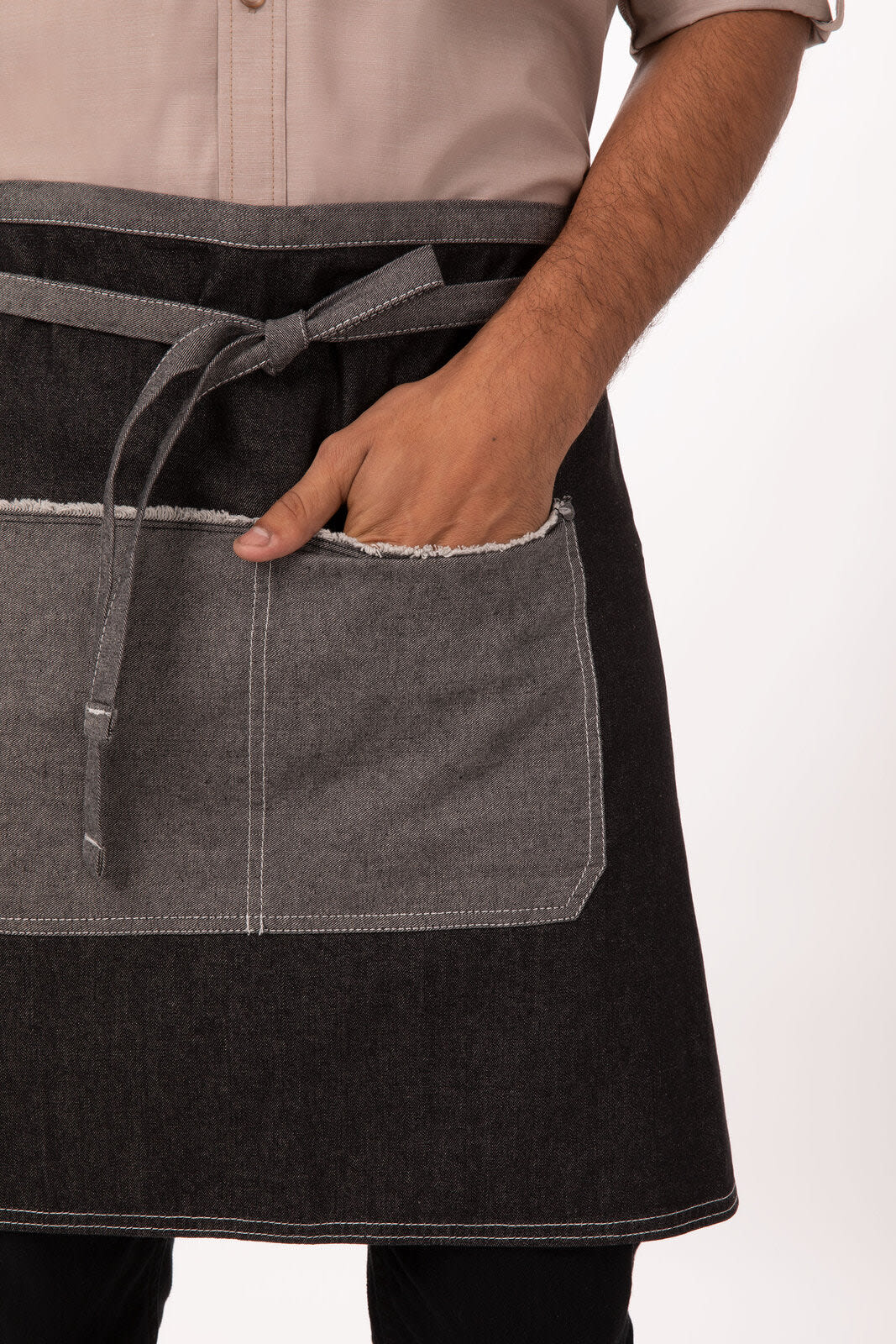 A half bistro apron featuring a dark denim design with a grey pocket, tied at the waist.