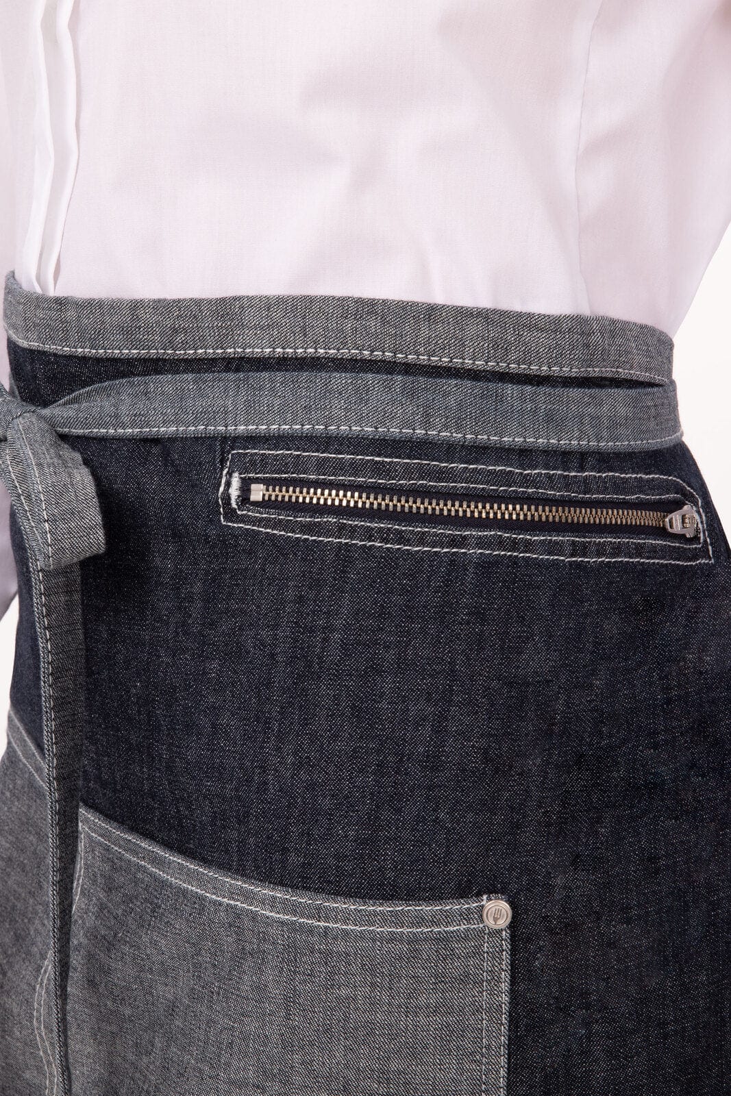 A half bistro apron in shades of dark grey with a front pocket and a zippered pocket on the side.