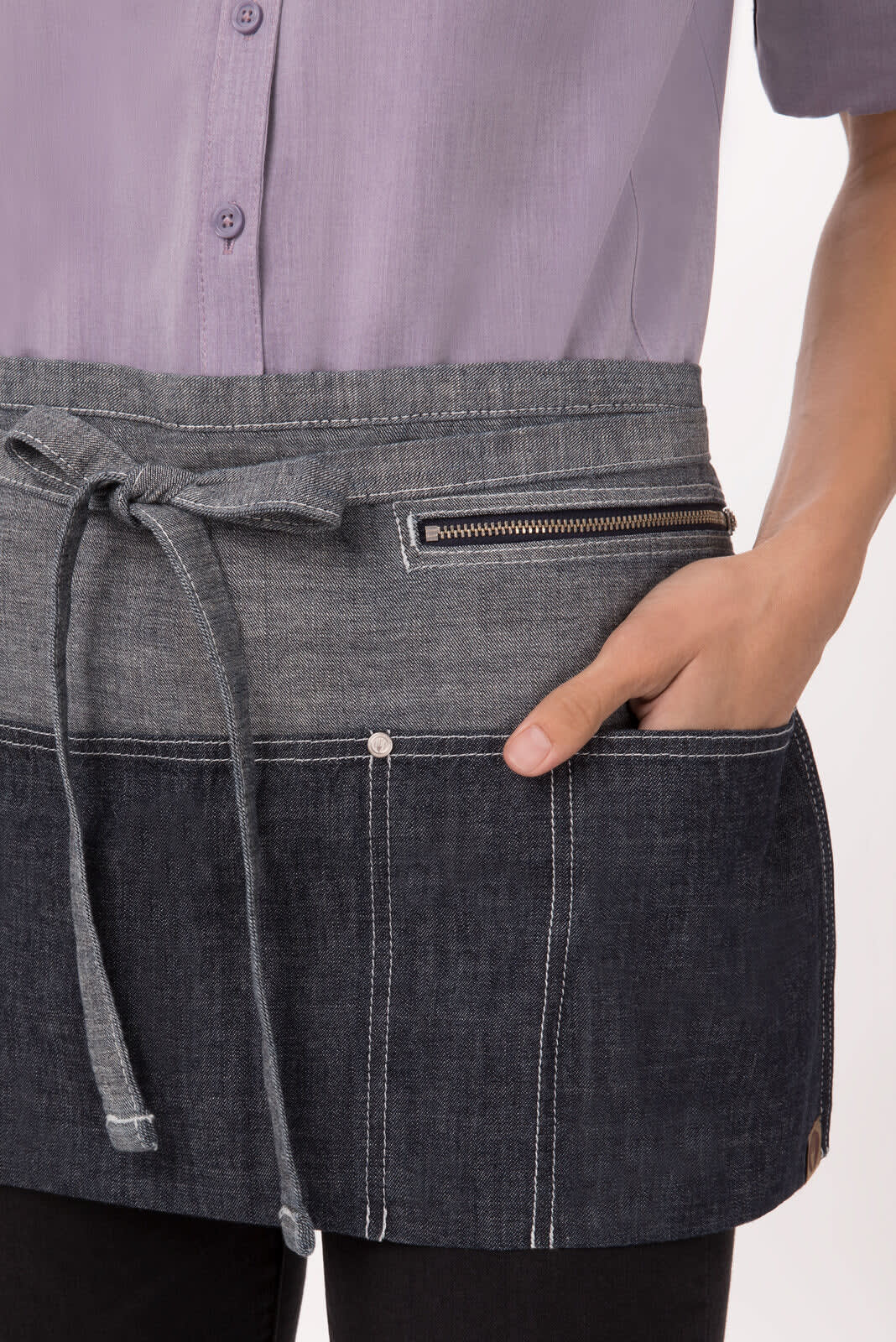 A denim apron featuring a dark and light blue design with a front pocket and a zippered compartment.