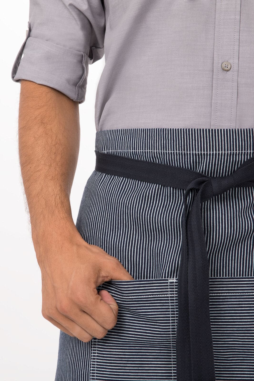 A striped bistro apron in navy and white, featuring a front pocket and tied at the waist.