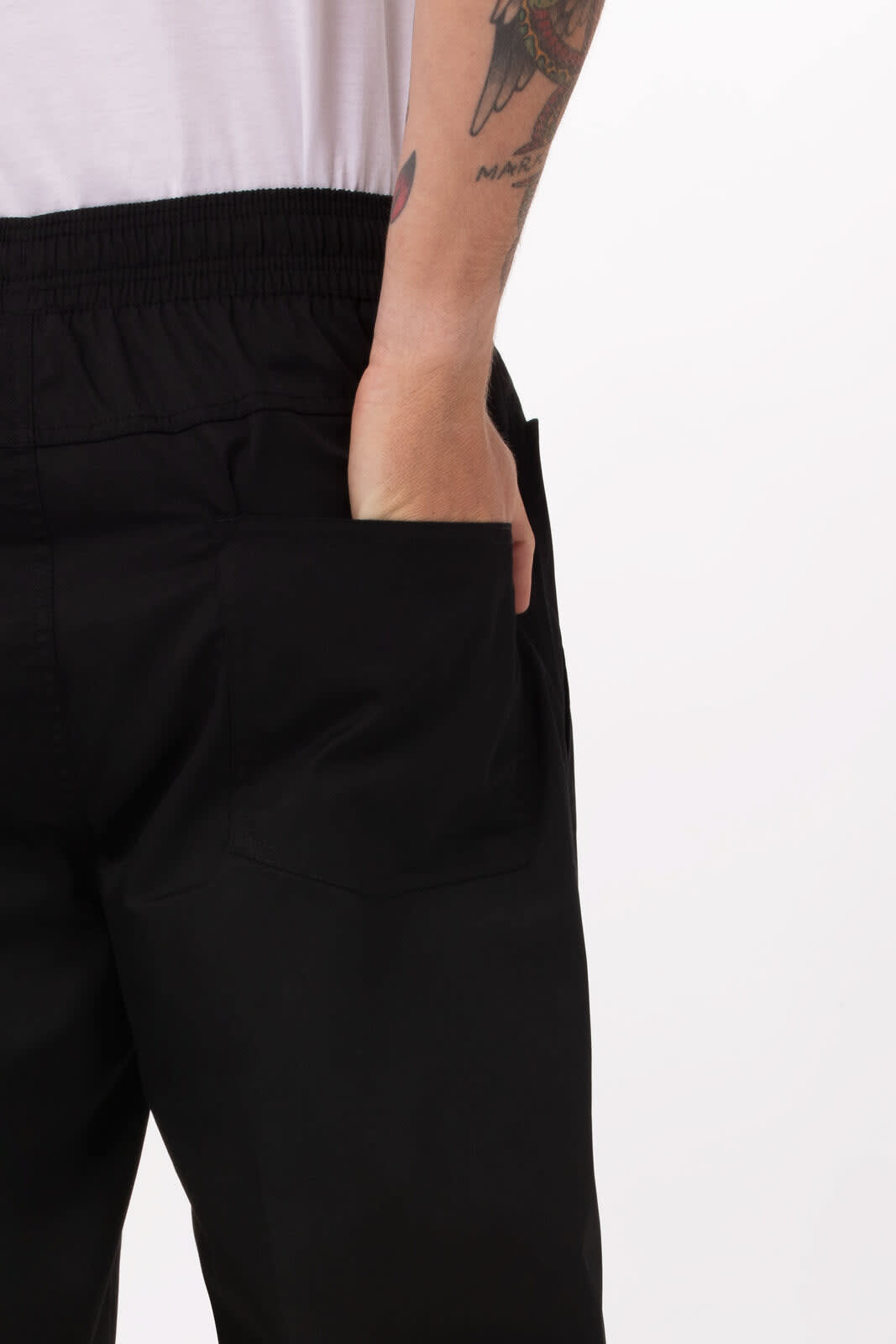 Lightweight baggy pants in black with visible side pockets and an elastic waistband. There is a tattoo on the arm.