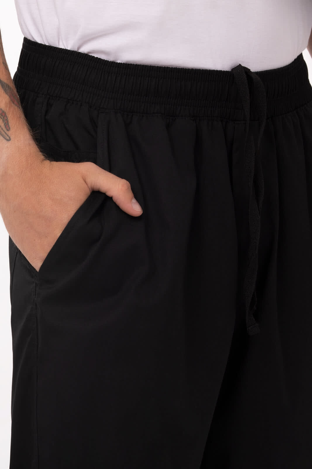 Lightweight baggy pants in black with side pockets and an elastic waistband. Features a drawstring for adjustable fit.