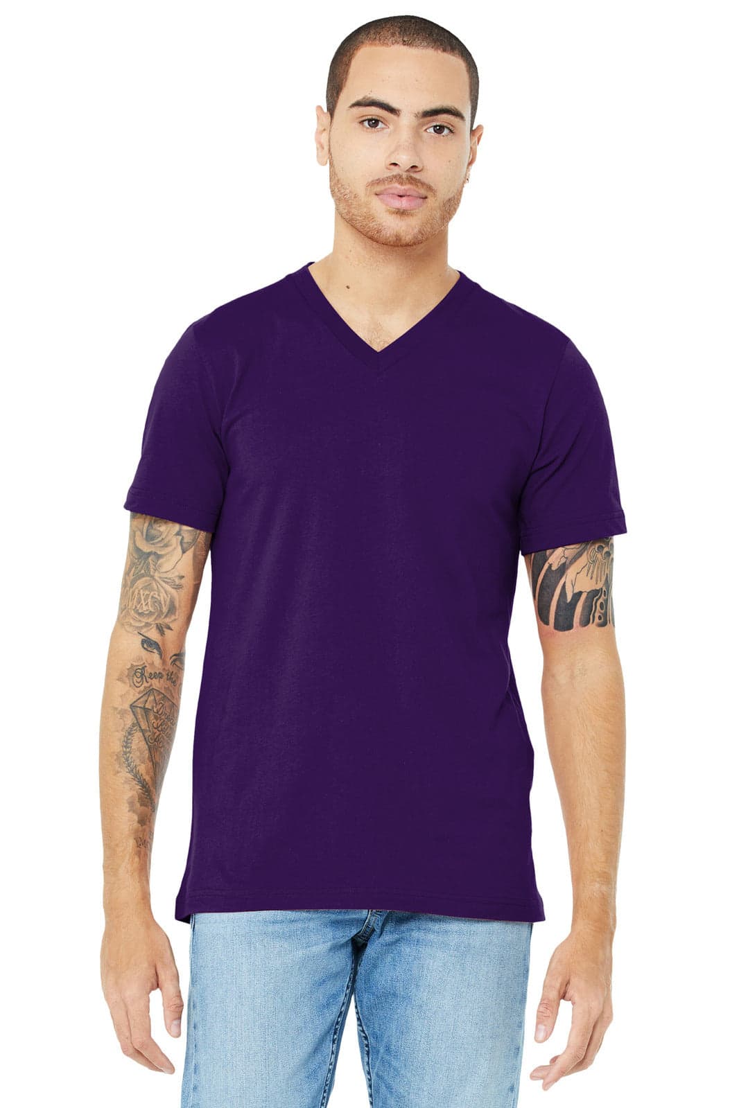 A unisex purple jersey short sleeve v-neck tee with a logo, worn by a model with tattoos.