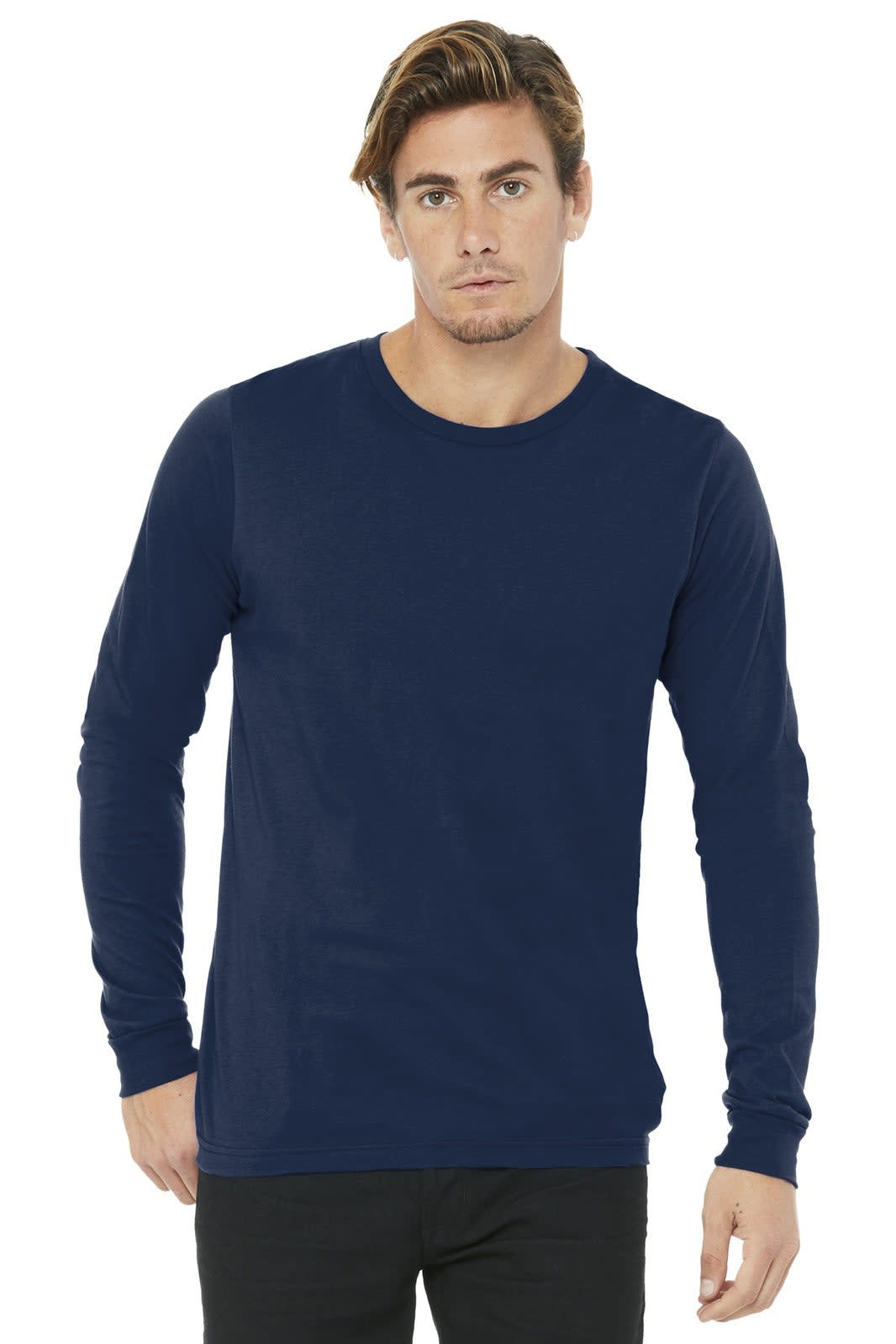 A man wearing a navy unisex long sleeve tee. The shirt features a logo on the chest area.
