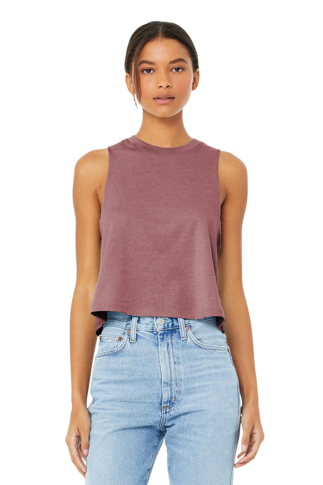A woman wearing a maroon cropped tank top with a relaxed fit, paired with blue jeans. The top has a logo.