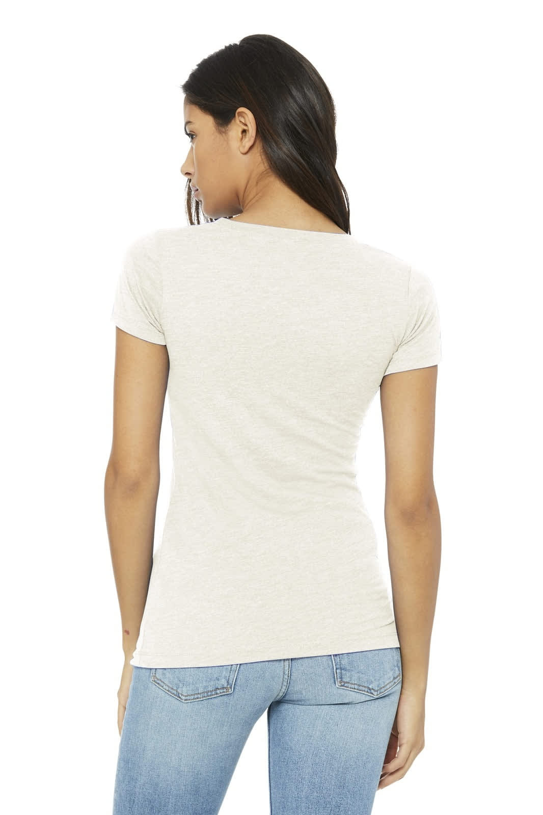 A woman models a light beige women's triblend short sleeve tee from the back, paired with blue jeans.