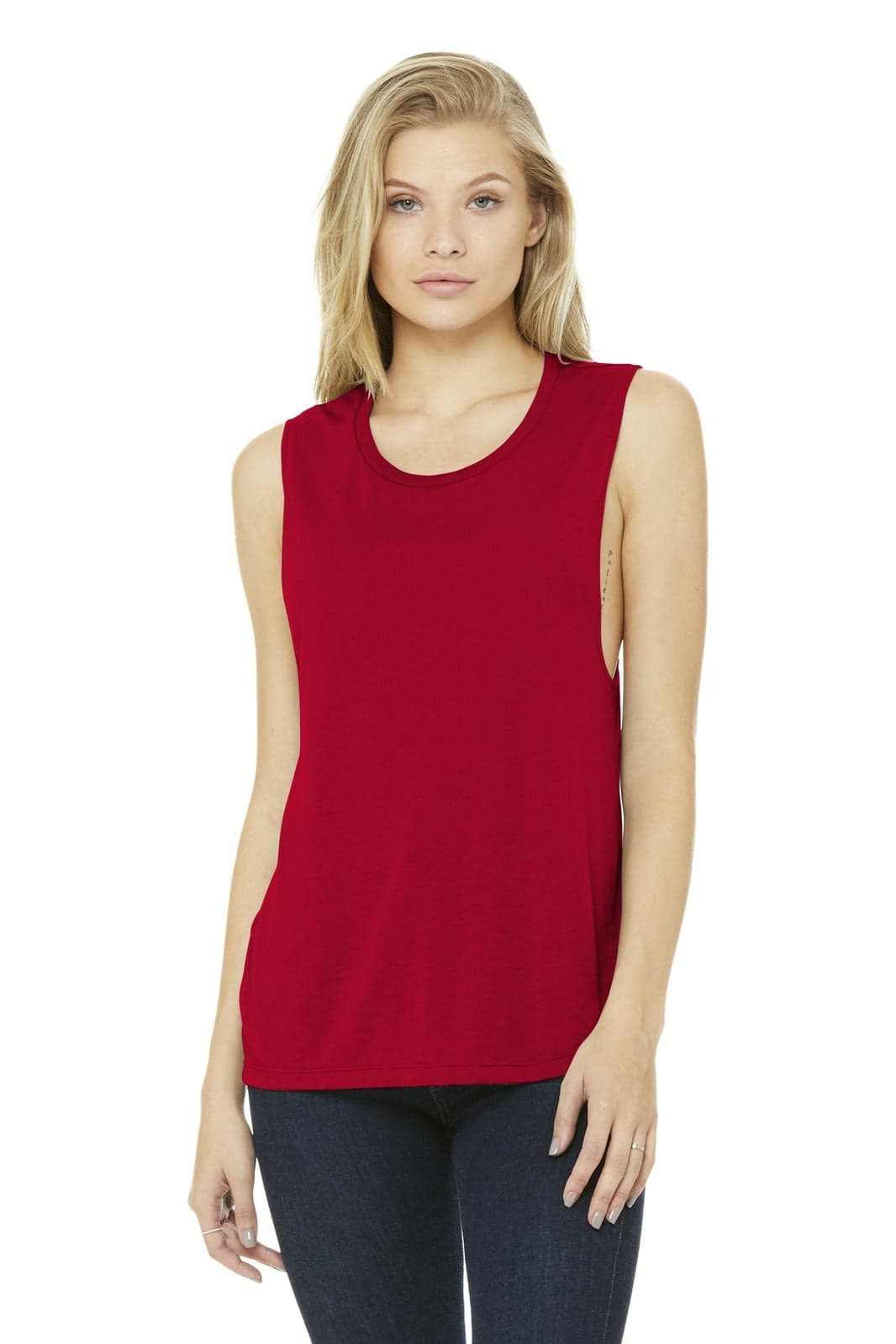 A woman models a red BELLA+CANVAS women's flowy scoop muscle tank, featuring sleeveless design and a logo.