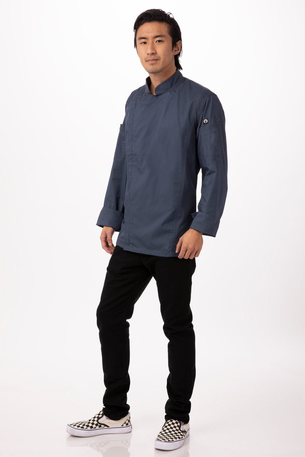 A chef jacket in navy blue, featuring a logo, worn by a model with black trousers and checkered shoes.