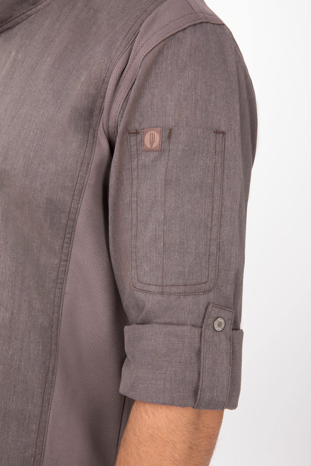 A grey chef jacket featuring rolled sleeves and a pocket on the arm, with a small logo present.