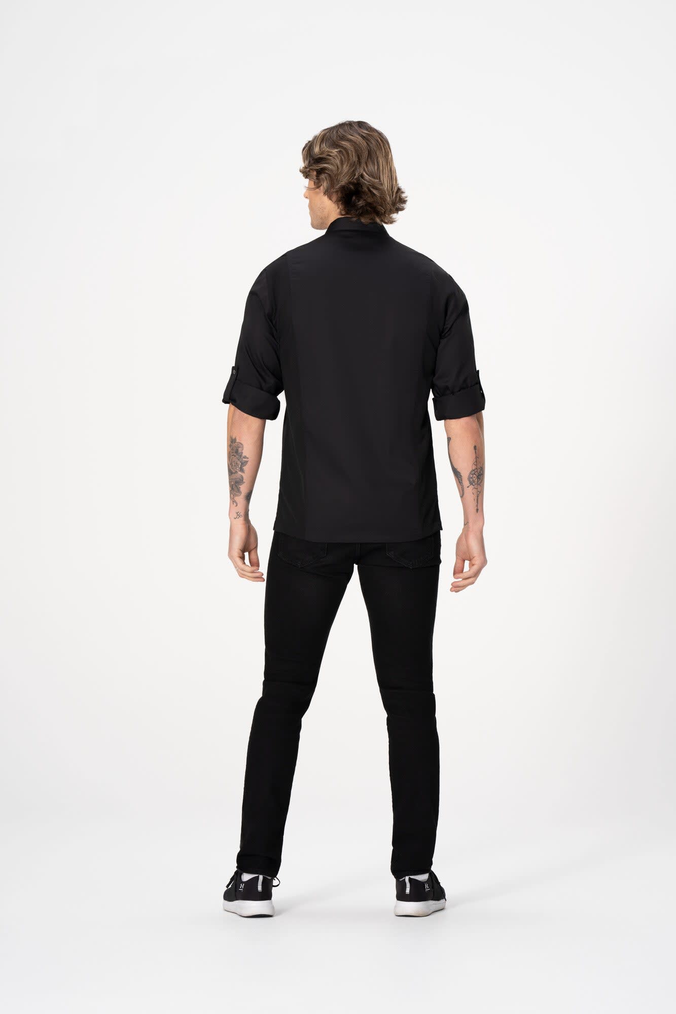 A men's black chef jacket with rolled sleeves, displayed from the back view, featuring a logo.