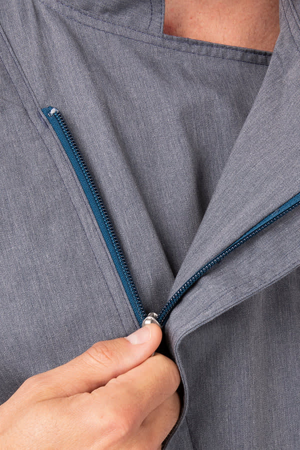 A men's chef jacket in grey with a blue zipper detail, showcasing the fabric texture and zipped opening.