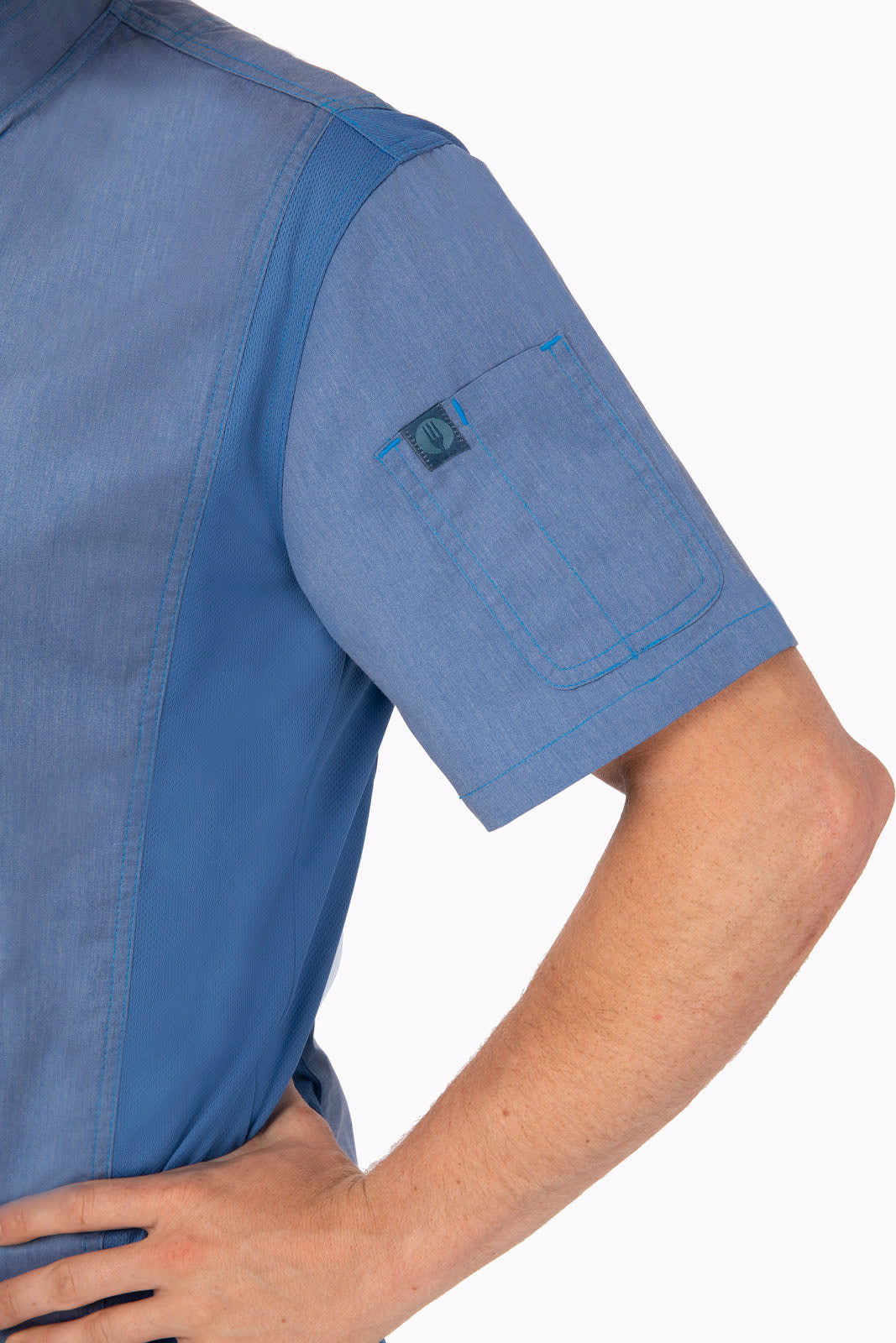 A short-sleeved blue chef jacket featuring a pocket on the arm and a logo. The fabric has a textured appearance.