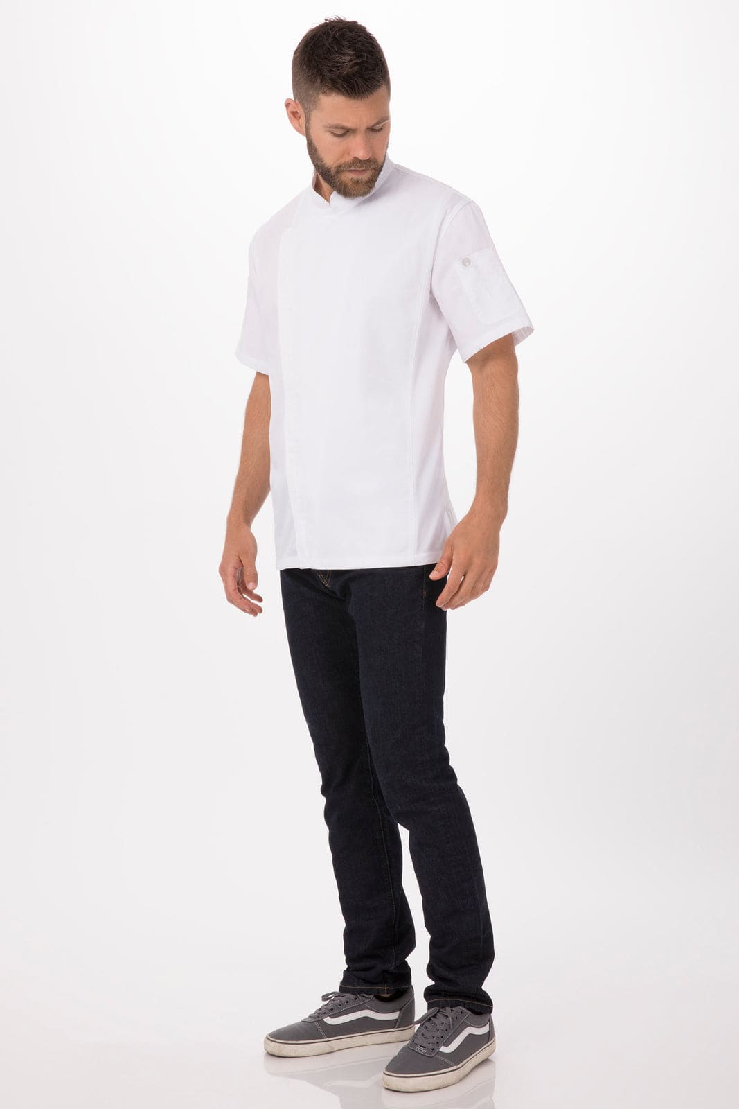 A chef jacket in white, featured on a model wearing black jeans and sneakers, with a logo on the sleeve.