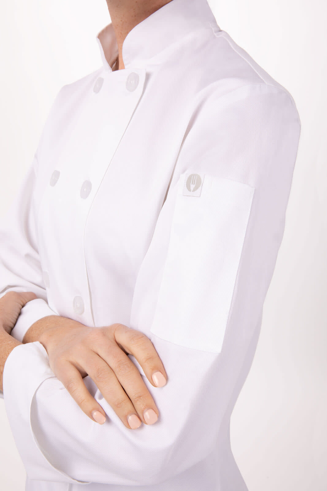 A white women's chef jacket featuring a double-breasted design and a buttoned cuff. It has a logo on the sleeve.