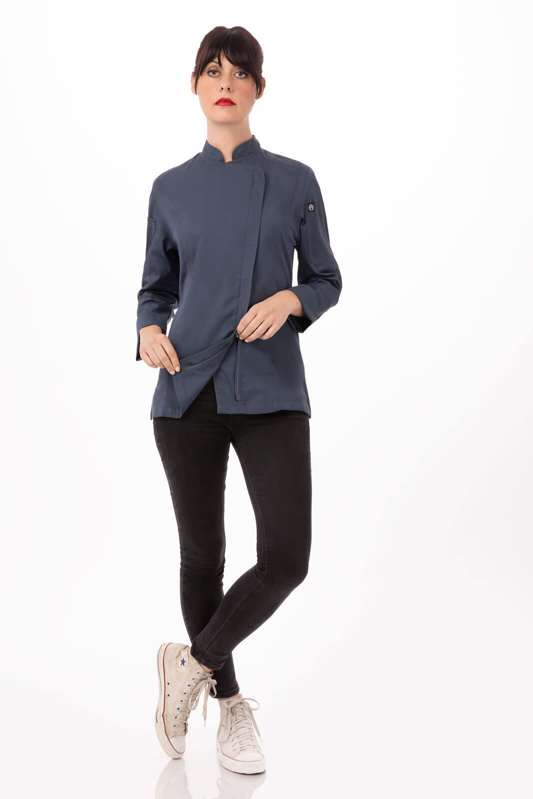 A women's chef jacket in navy blue, featuring a mandarin collar and long sleeves, paired with black pants and casual shoes.