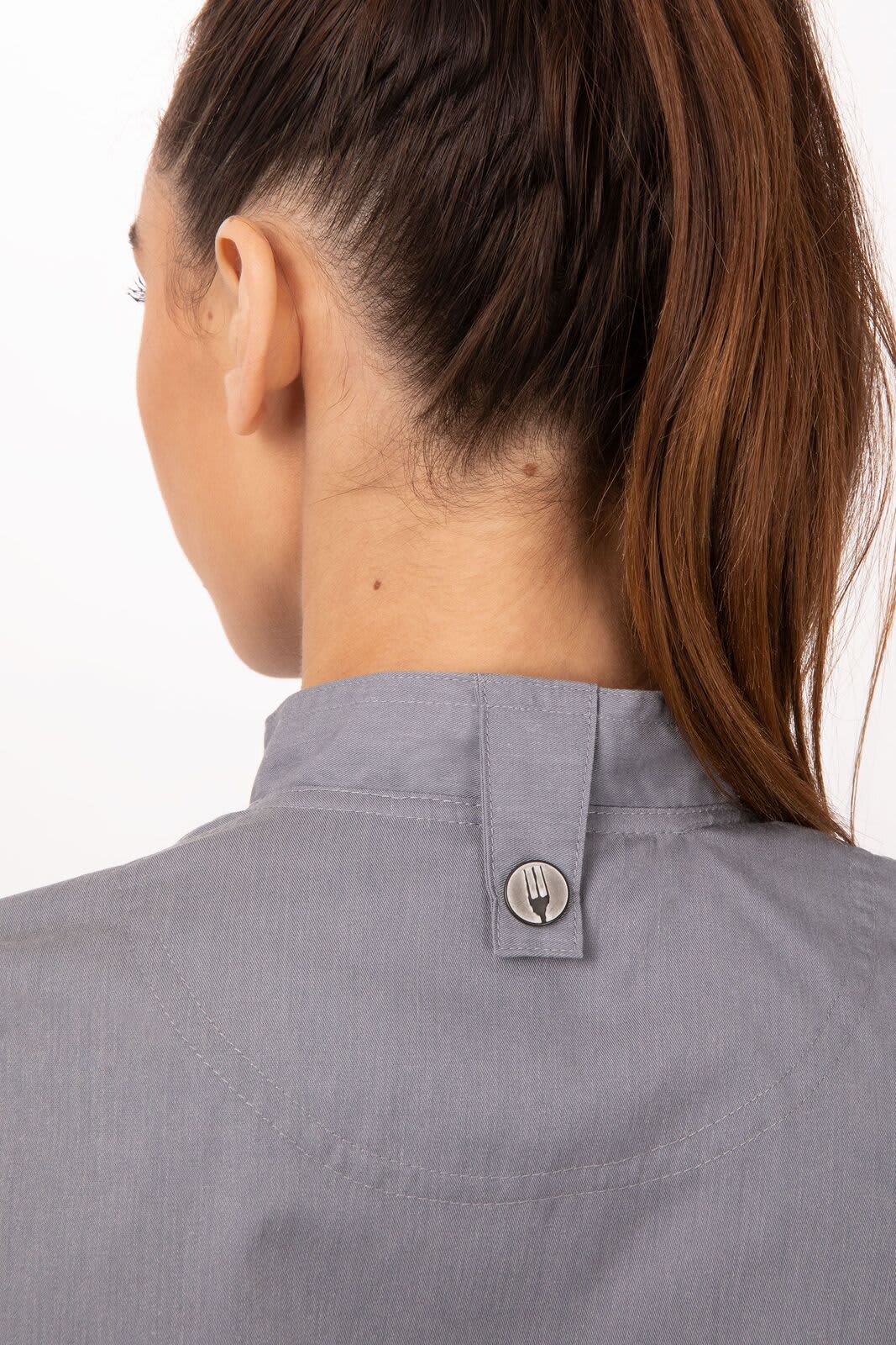 A grey women's chef jacket with a stylish back design and a branded logo. Suitable for kitchen wear.