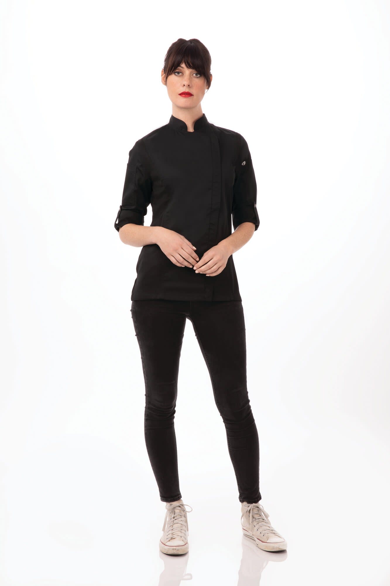 A black women's chef jacket displayed on a model with a sleek design and an embroidered logo.