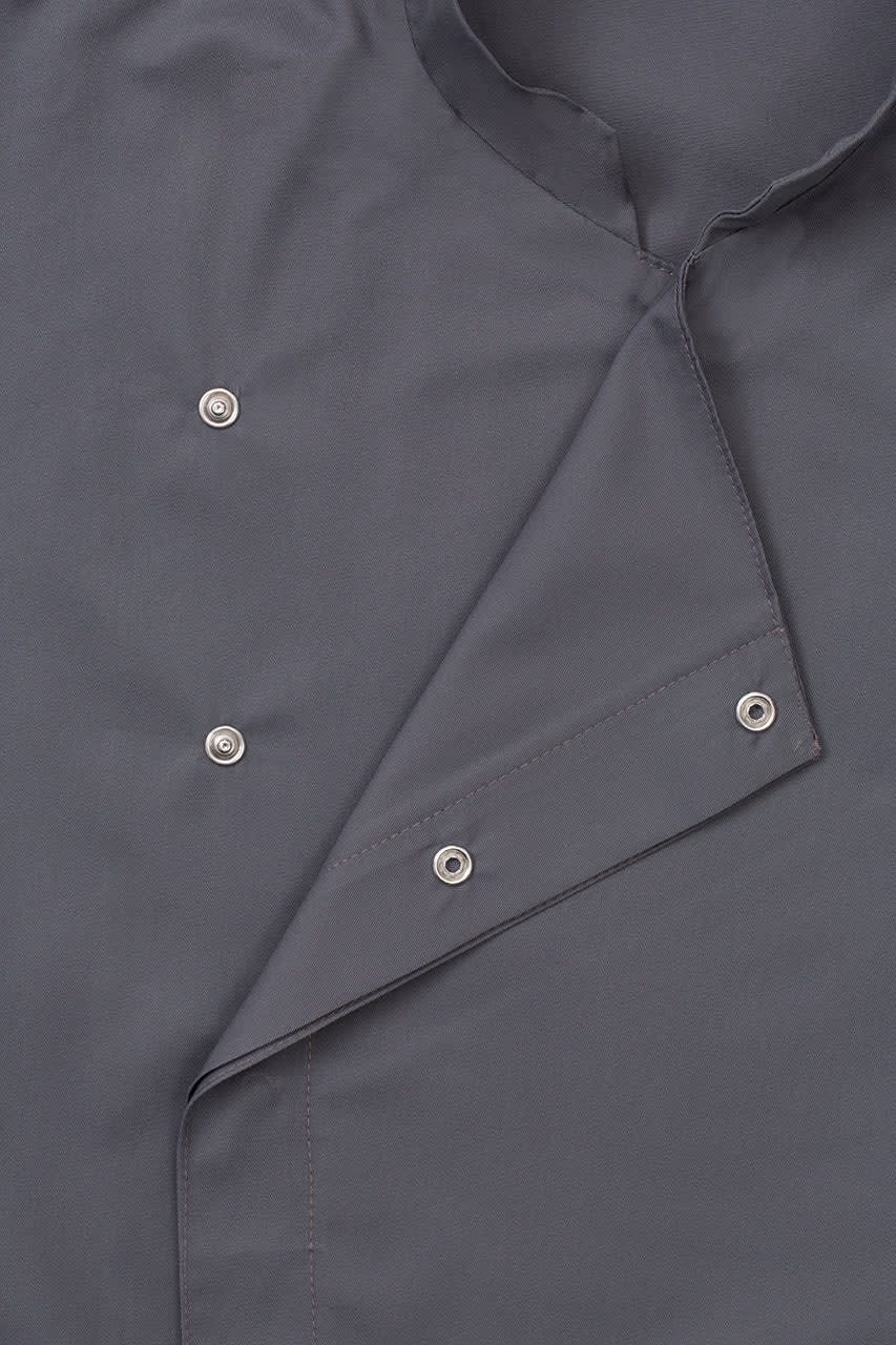 A grey women's chef jacket featuring snap buttons and a folded collar, with a branding logo.