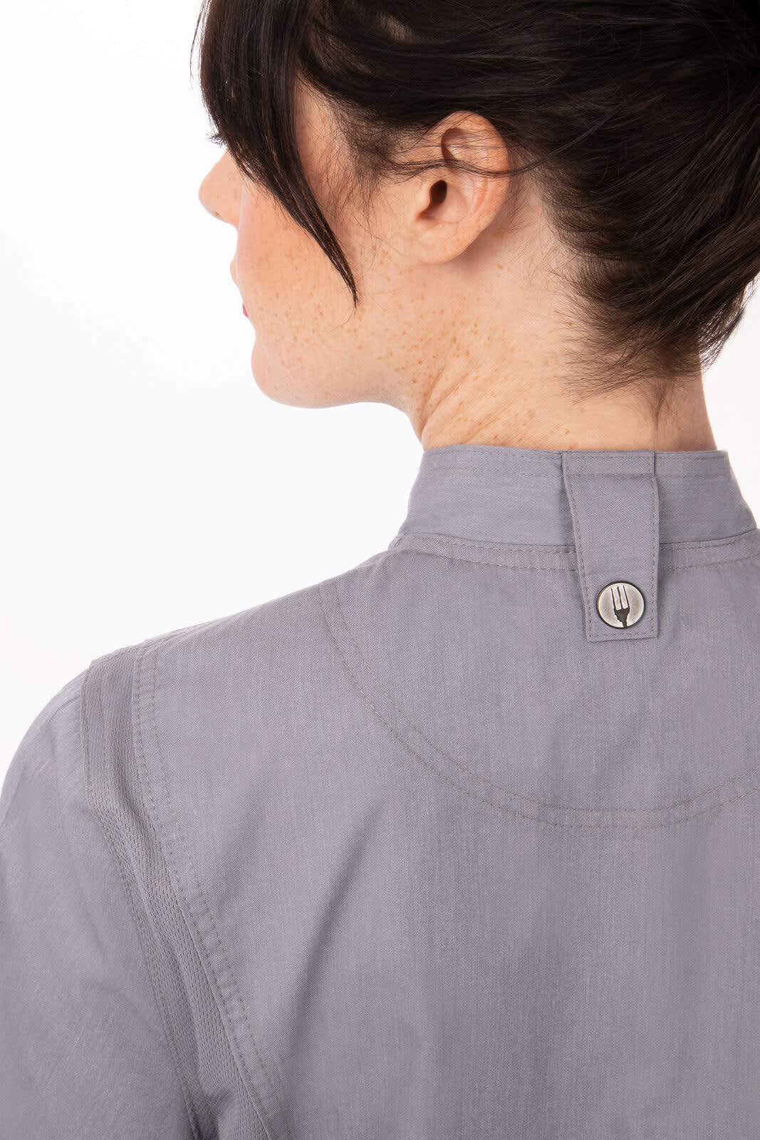 A women's chef jacket in grey, featuring a high collar and a button detail at the back.