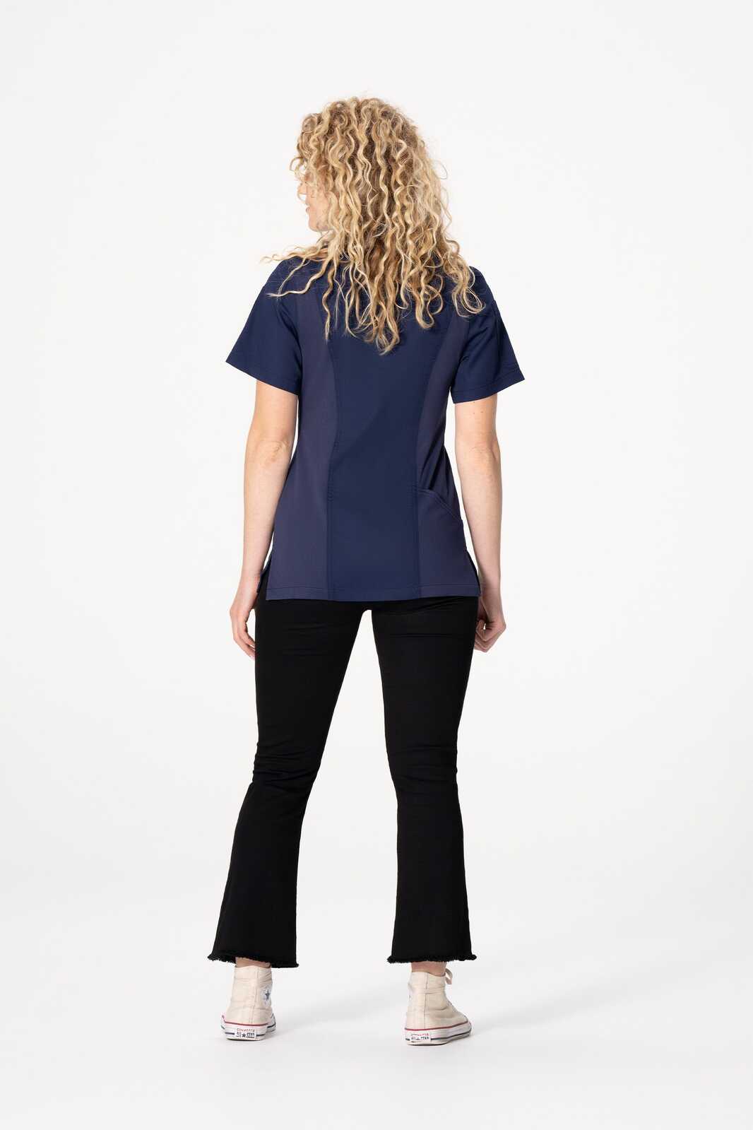 A women's chef jacket in navy blue, featuring a branded logo and a stylish fit, paired with black pants.